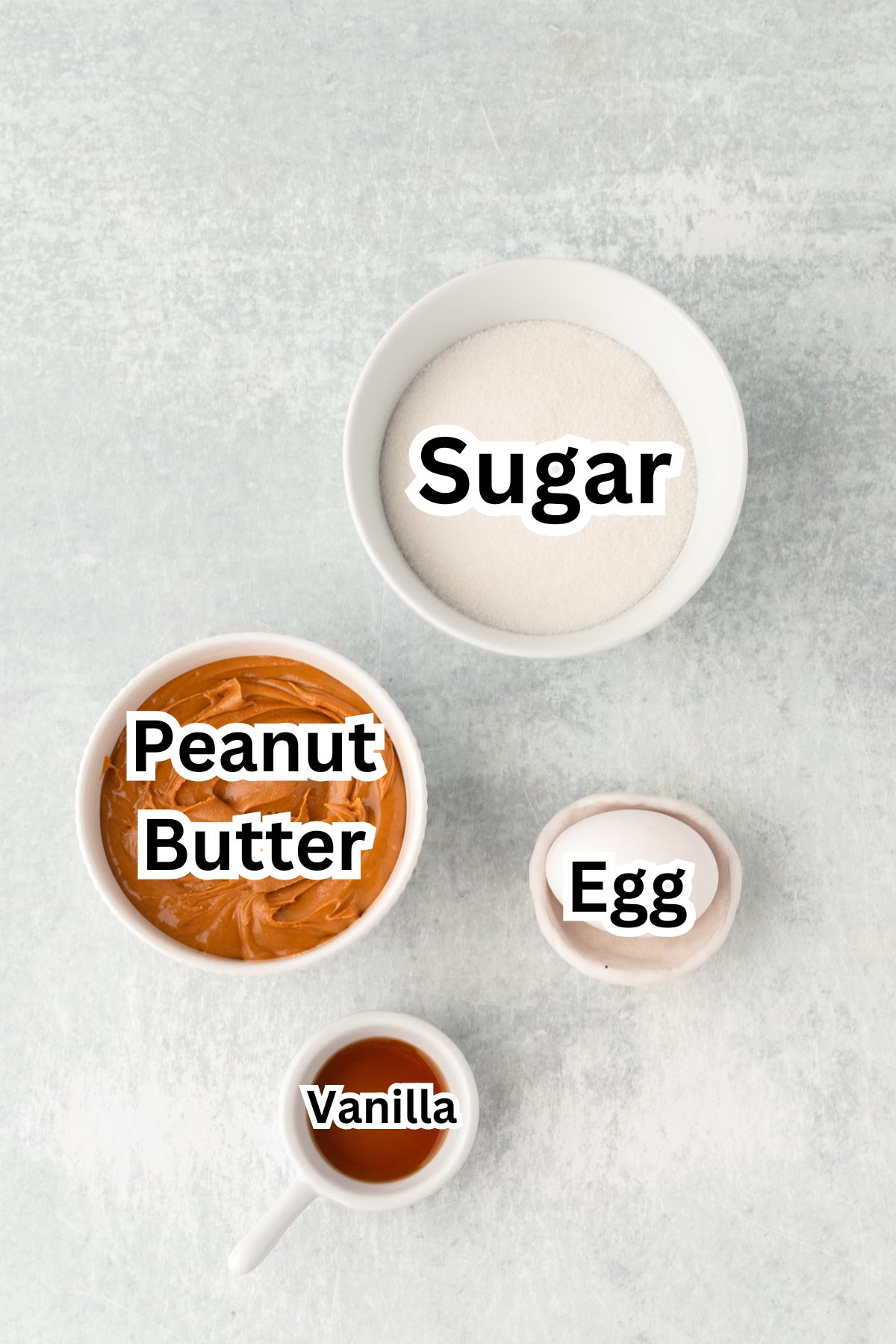 Ingredient in white bowls for 4 ingredient peanut butter cookies.