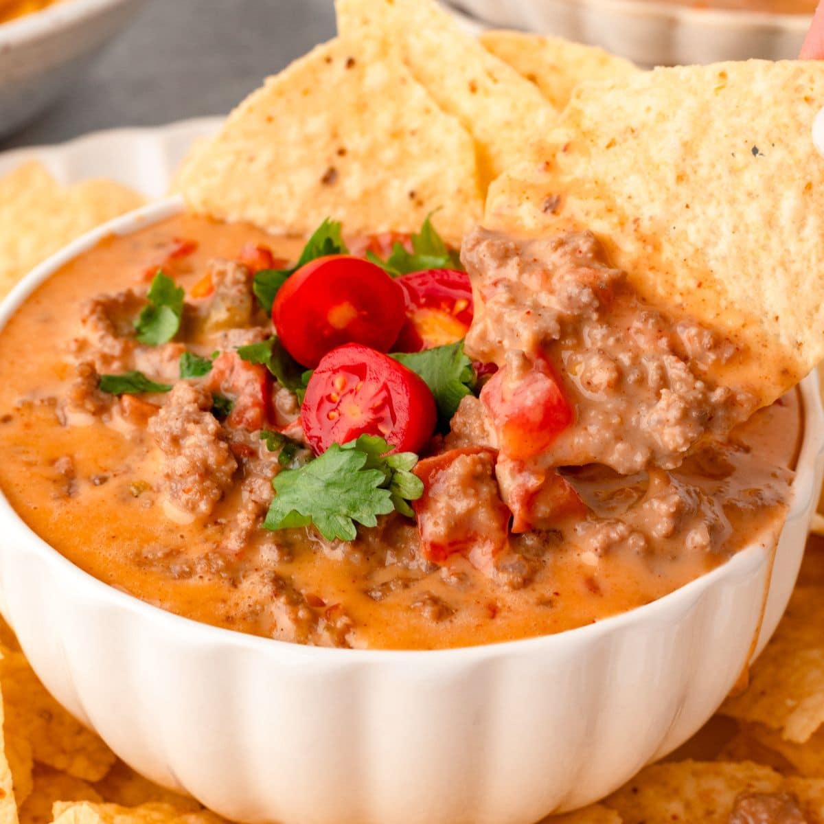 Savory beef chili served with tortilla chips and fresh cherry tomatoes.