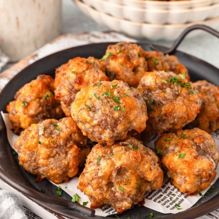 Bisquick Sausage Balls garnished with parsley served on black plate.