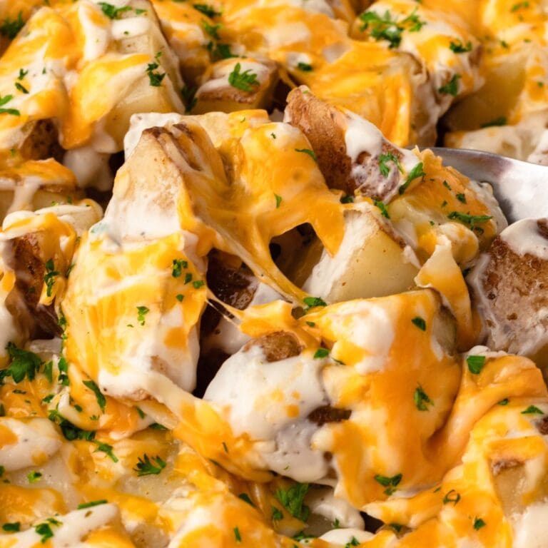 Cheesy loaded potato skins with melted cheese, sour cream, and herbs, perfect for snack or appetizer.