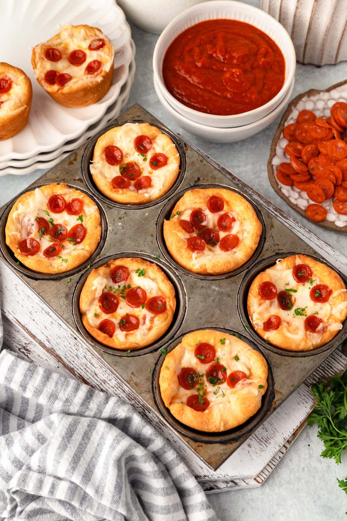 Cream cheese pizza bites topped with cherry tomatoes, served with marinara sauce.