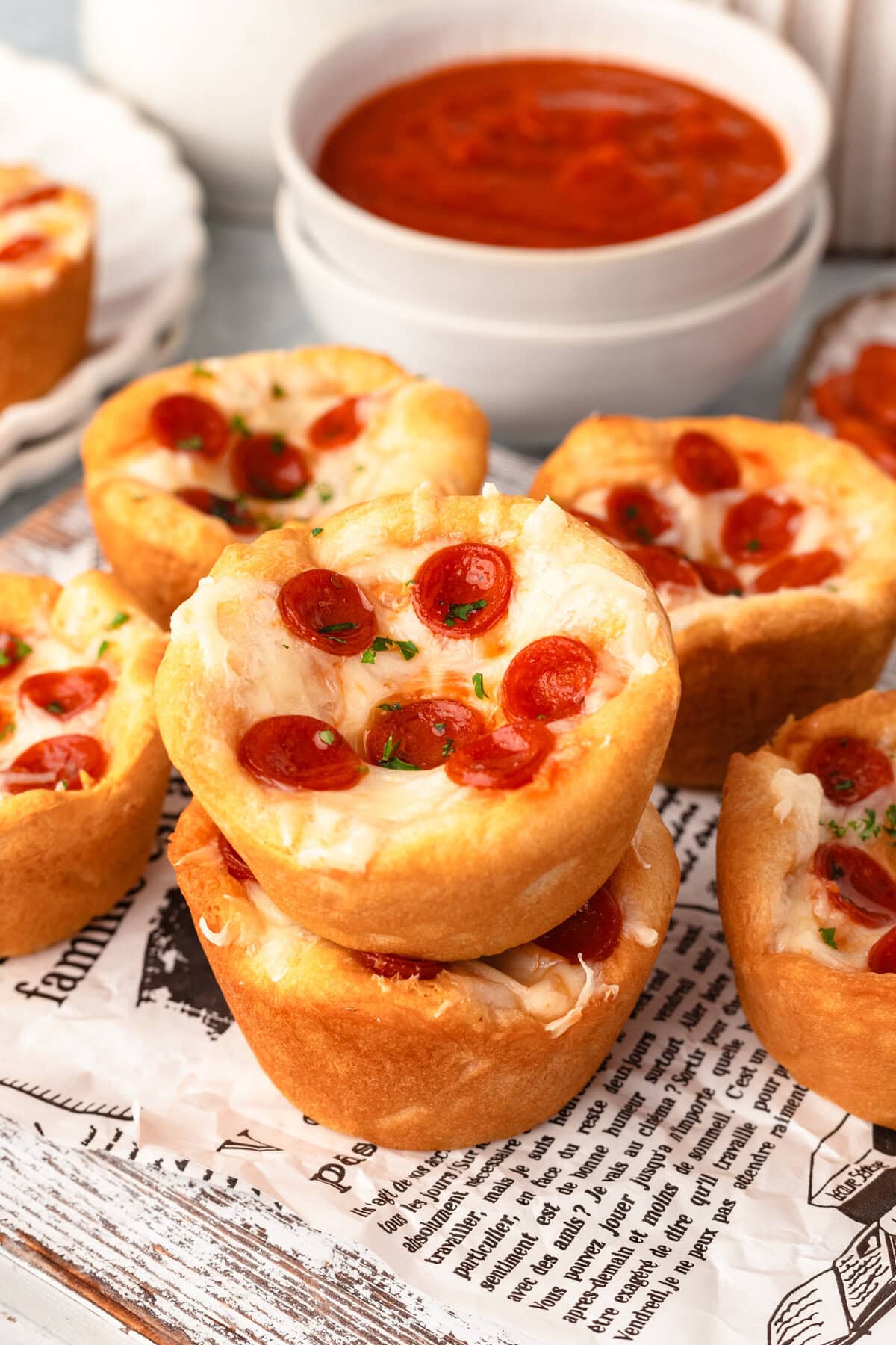 Savory mini pepperoni pizza muffins with melted cheese and fresh herbs. Perfect snack or appetizer.